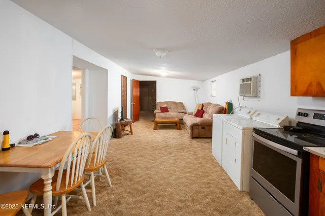 a living room with furniture a fireplace a flat screen tv and a window
