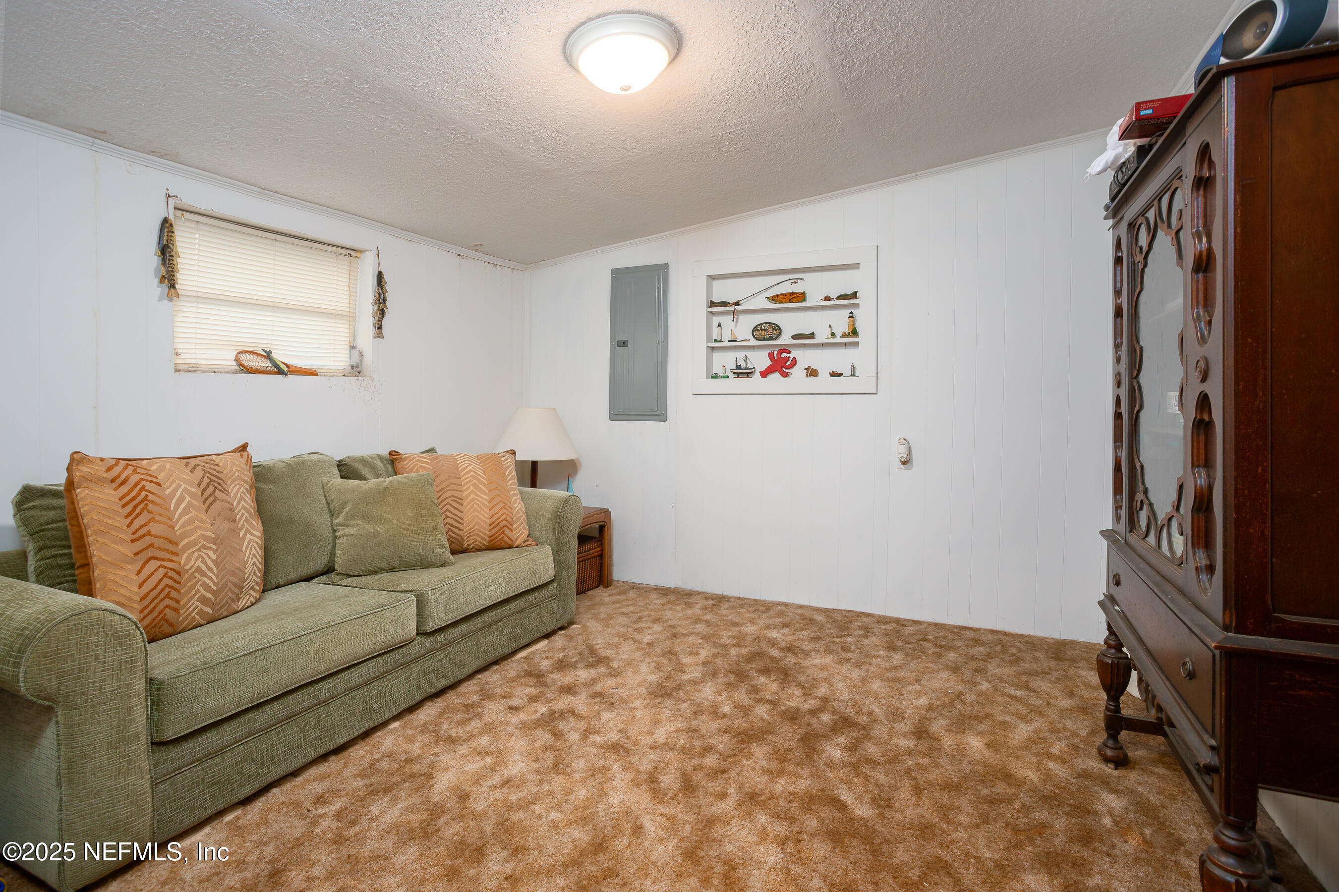 663 Carlin Road Satsuma, FL 32189 - Photo 16 of 19 a living room with a couch and a flat screen tv