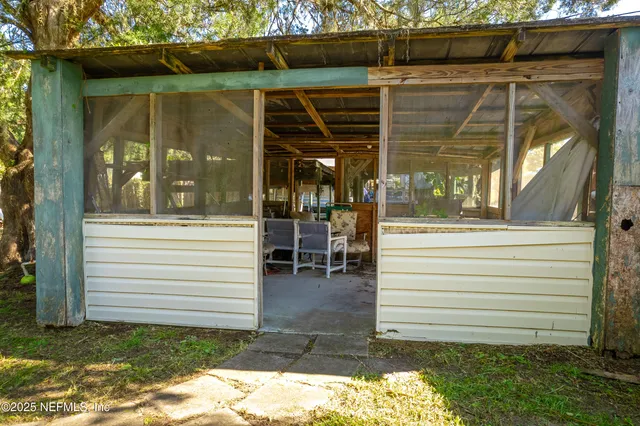 a view of a porch with a door and a bench