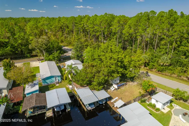 an aerial view of a house with a garden and pool