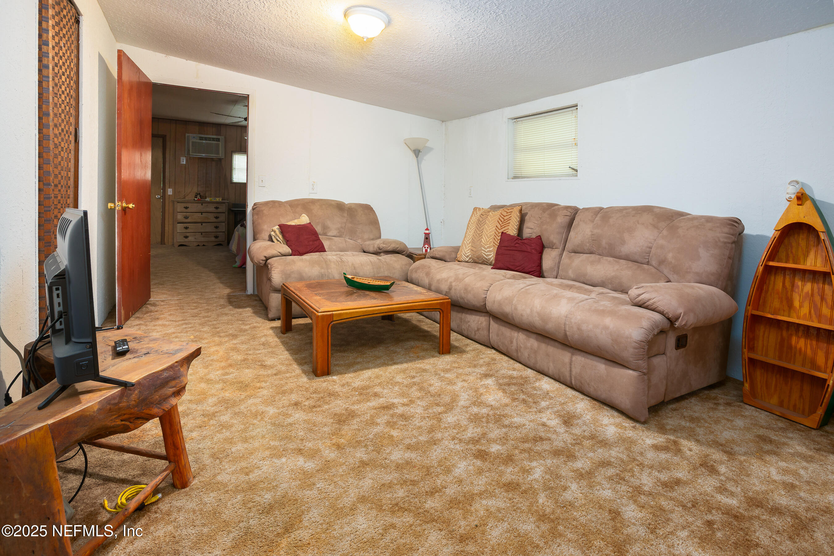 663 Carlin Road Satsuma, FL 32189 - Photo 10 of 19 a living room with furniture and a flat screen tv