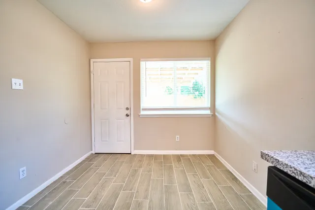 wooden floor in an empty room with a window