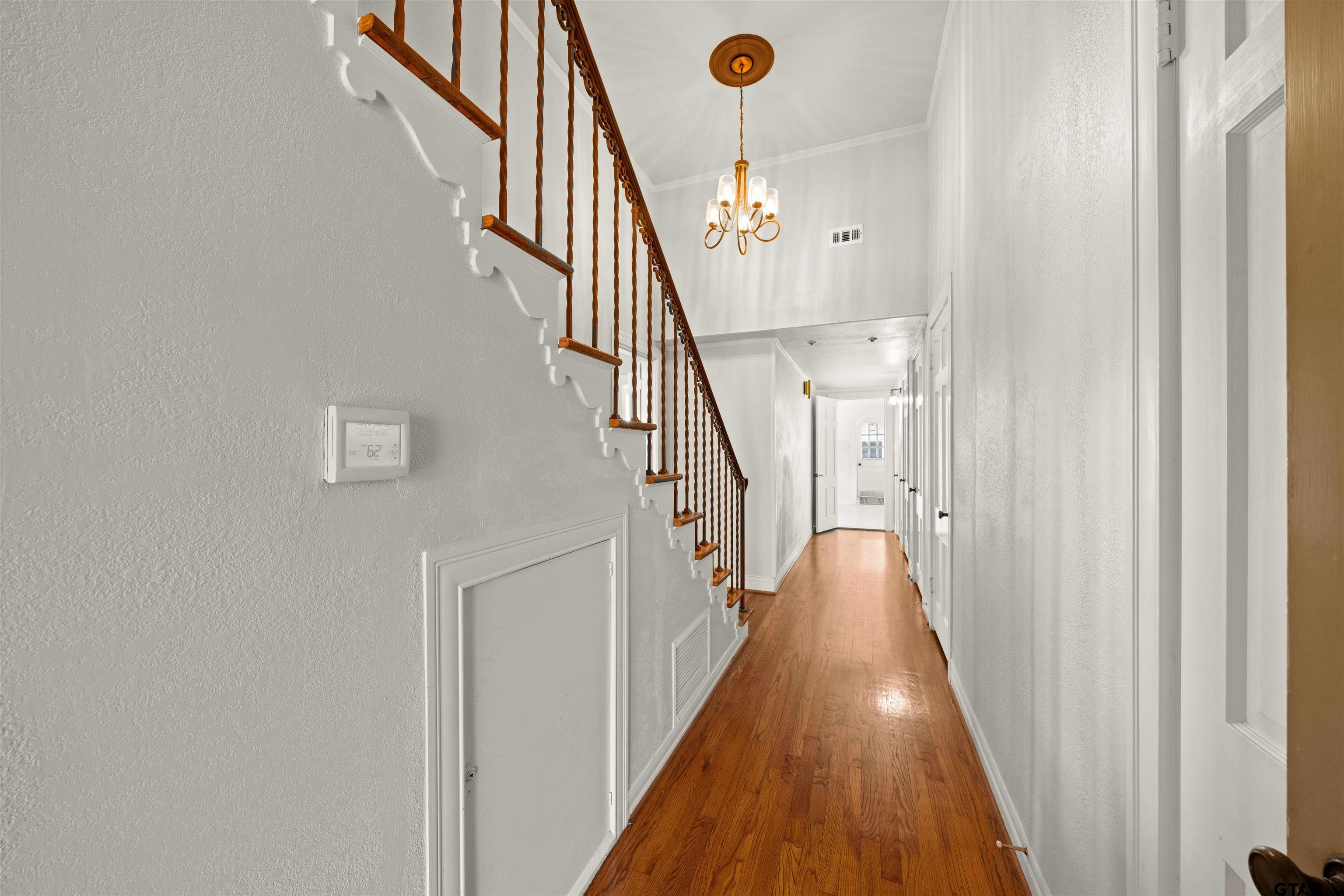 213 East 2nd Street Tyler, TX 75701 - Photo 8 of 48 a view of a hallway with wooden floor and staircase