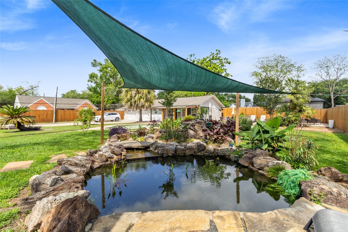 1914 Peppermill Road Houston, TX 77080 - Photo 12 of 43 Tucked away like your own private escape, this shaded pond adds a peaceful, almost resort-like corner where you can slow things down and reset.