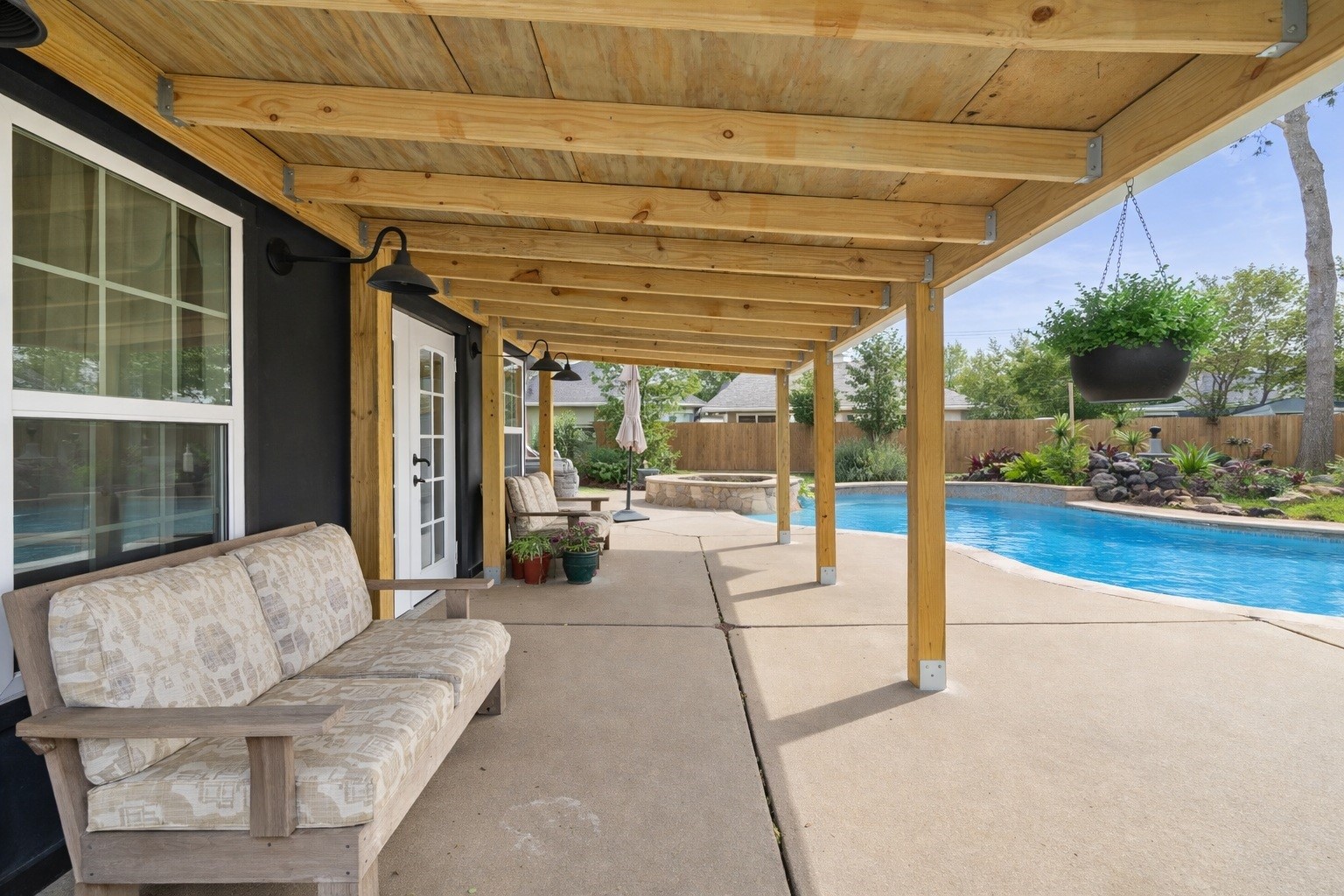 1914 Peppermill Road Houston, TX 77080 - Photo 14 of 43 Step outside and settle in—your covered patio puts you right next to the pool, giving you a shaded spot to unwind while staying connected to the action.