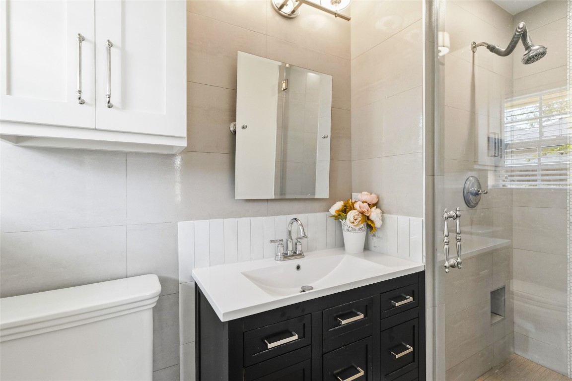 1914 Peppermill Road Houston, TX 77080 - Photo 36 of 43 Clean, modern finishes make this bathroom feel fresh and functional, with a sleek vanity and walk-in shower that keeps your daily routine simple and streamlined.