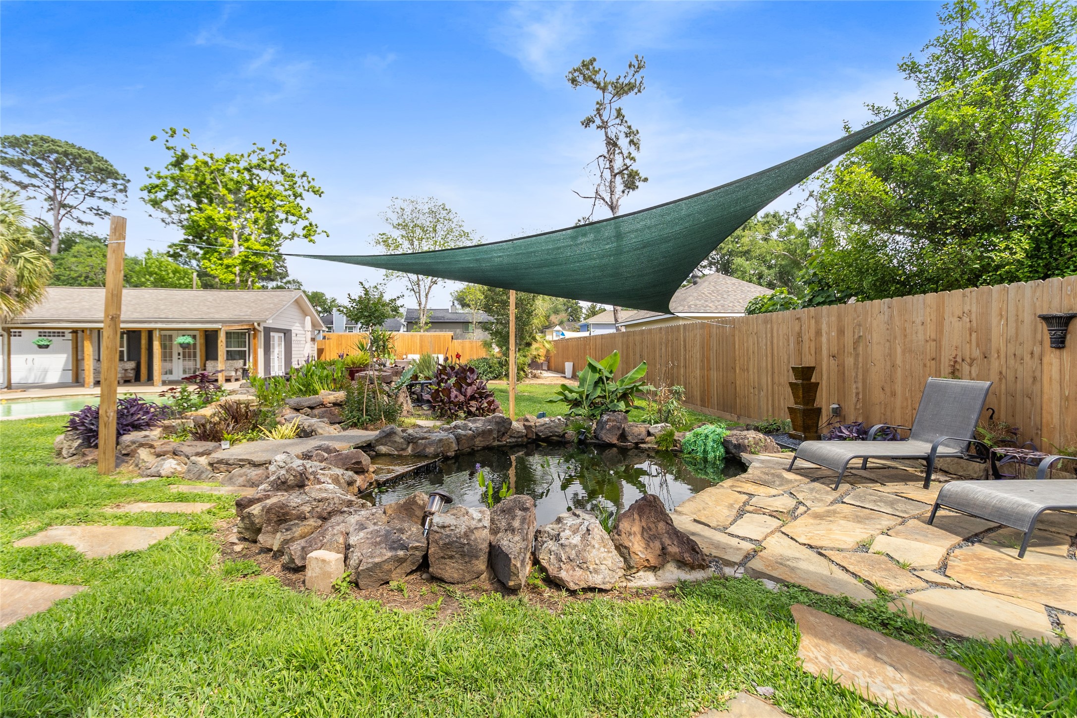 1914 Peppermill Road Houston, TX 77080 - Photo 41 of 43 Another perspective, same calm energy—lounge nearby, listen to the water, and enjoy a space that feels completely separate from everything else.