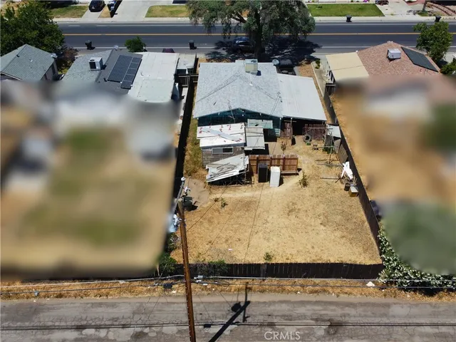 an aerial view of a house with a yard and sitting space