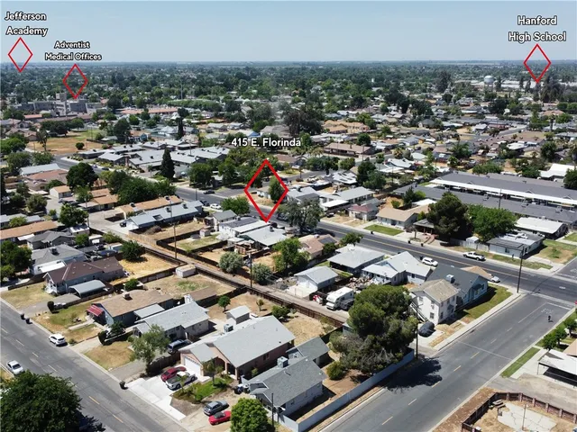 an aerial view of residential houses with outdoor space