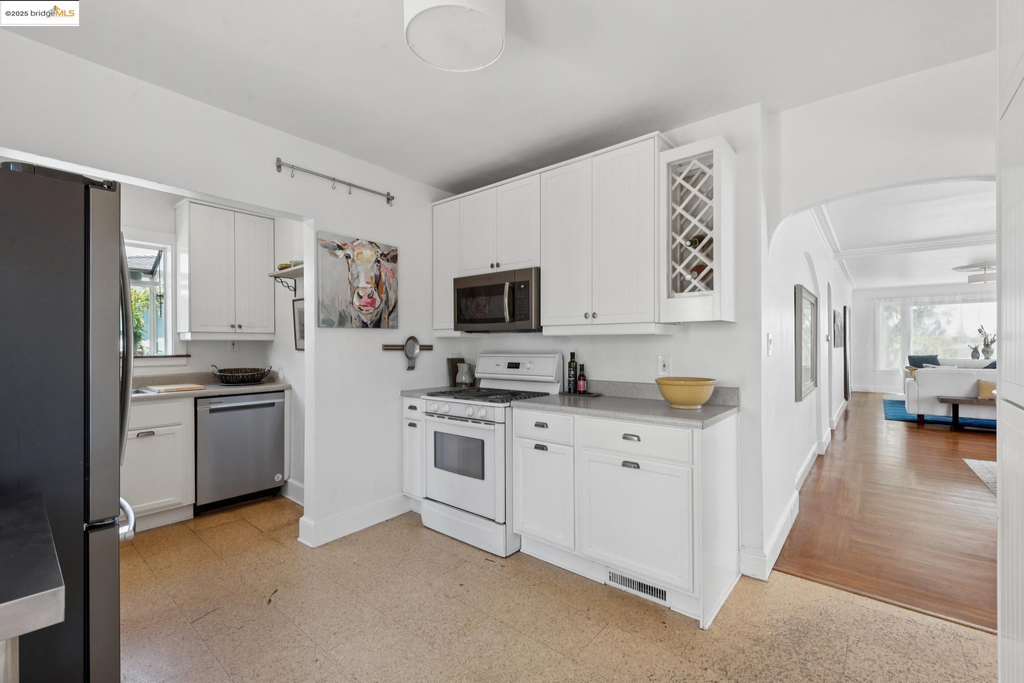 2721 Best Avenue Oakland, CA 94619 - Photo 11 of 28 Kitchen featuring arched walkways, healthy amount of natural light, stainless steel appliances, and light floors