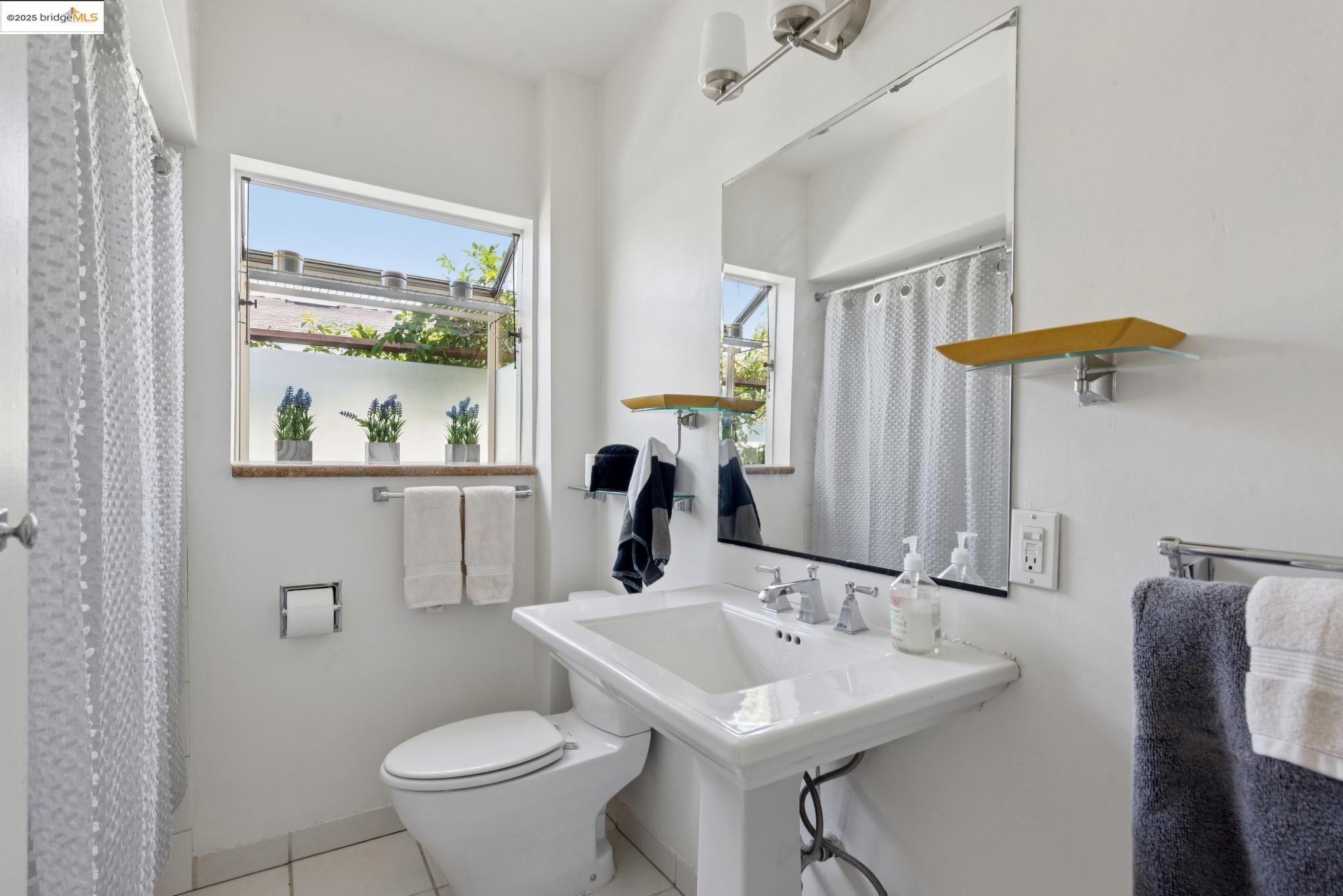 2721 Best Avenue Oakland, CA 94619 - Photo 19 of 28 Full bathroom featuring light tile patterned floors and a shower with curtain