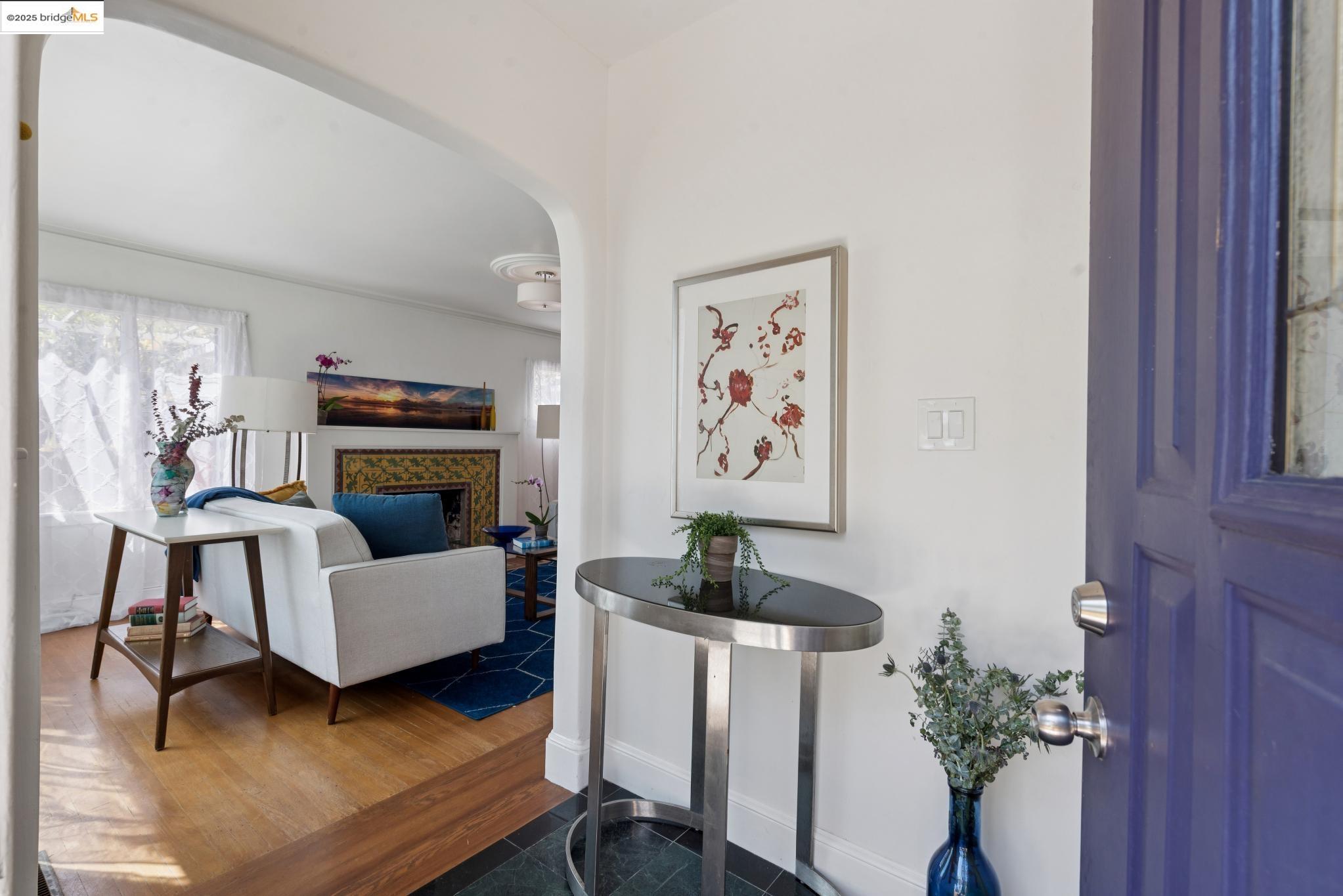 2721 Best Avenue Oakland, CA 94619 - Photo 3 of 28 Entryway featuring a tiled fireplace, dark wood-type flooring, and arched walkways