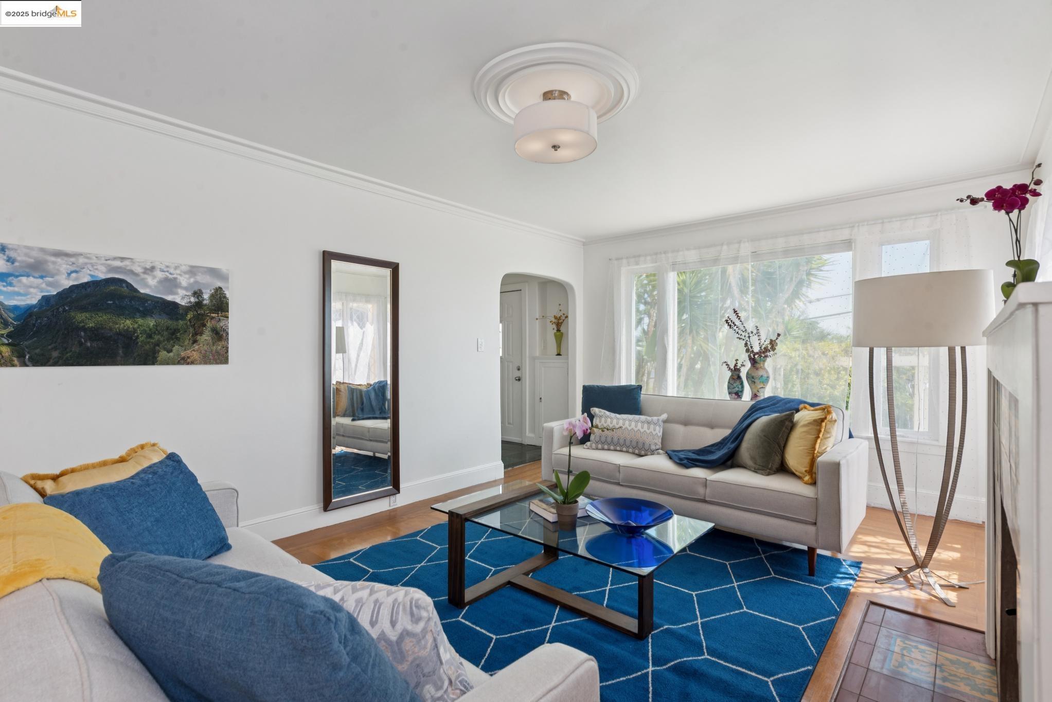 2721 Best Avenue Oakland, CA 94619 - Photo 4 of 28 Living area featuring arched walkways, ornamental molding, and wood finished floors