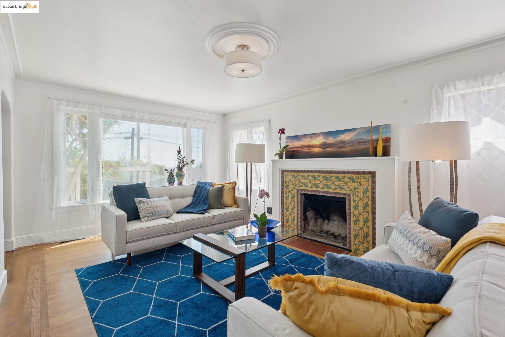 2721 Best Avenue Oakland, CA 94619 - Photo 5 of 28 Living room featuring wood finished floors, a fireplace, and crown molding