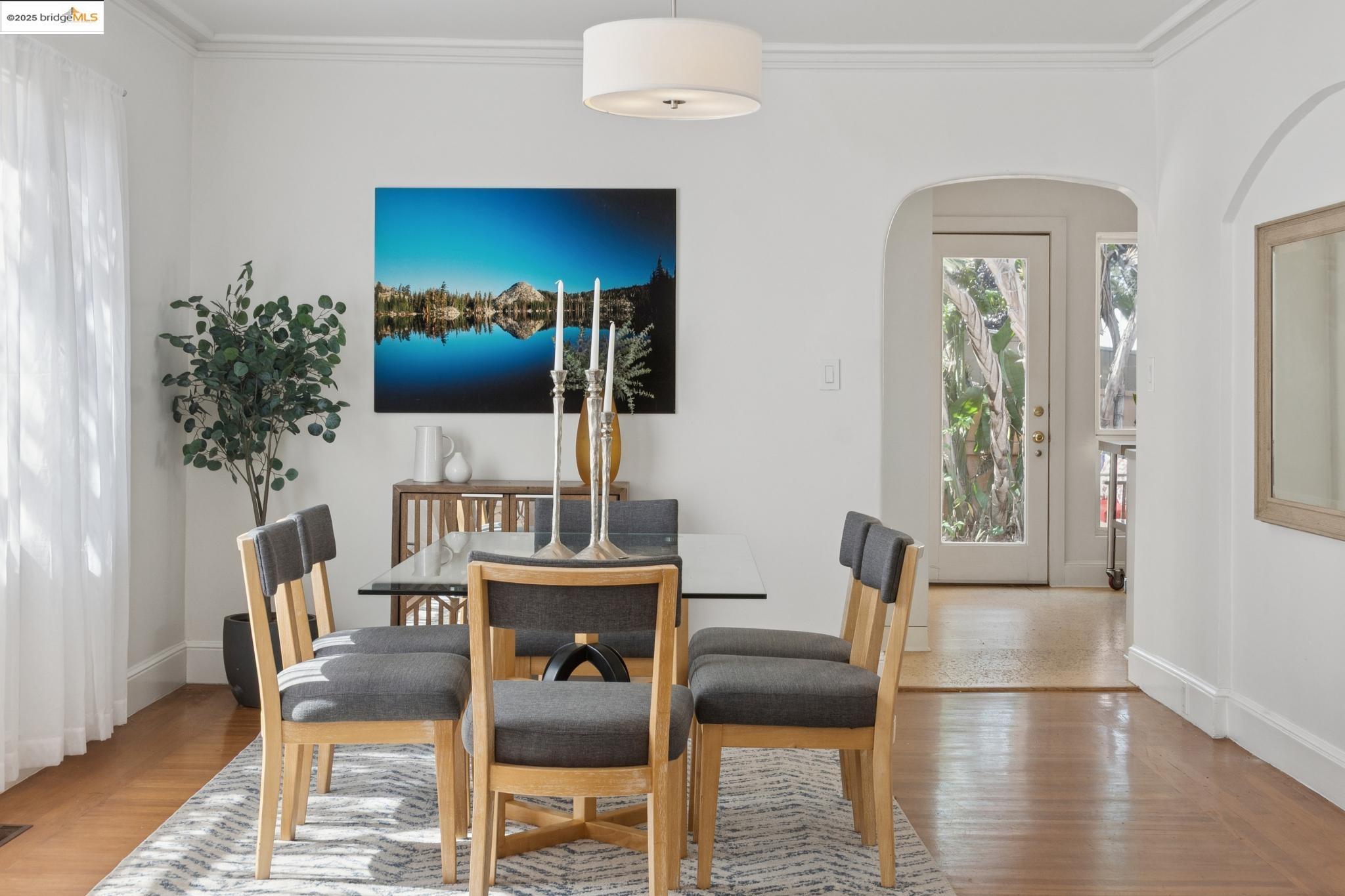 2721 Best Avenue Oakland, CA 94619 - Photo 9 of 28 Dining room featuring ornamental molding, light wood-type flooring, and arched walkways