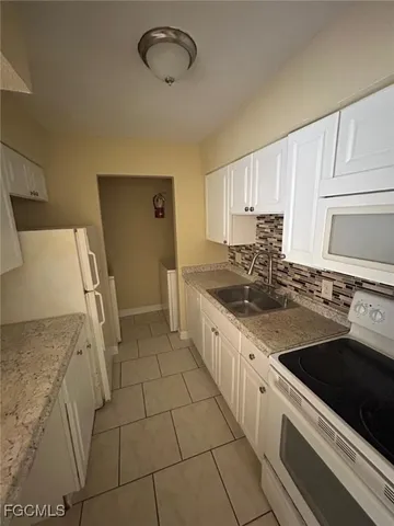 a kitchen with stainless steel appliances a sink stove and cabinets