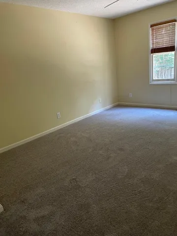 a view of hallway with furniture and a window