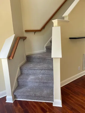 a view of entryway and hall with wooden floor