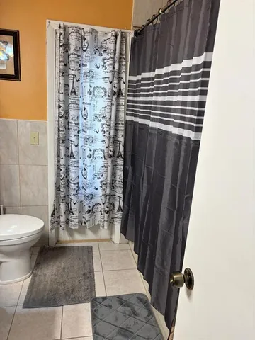 a kitchen with stainless steel appliances kitchen island granite countertop a refrigerator and a stove