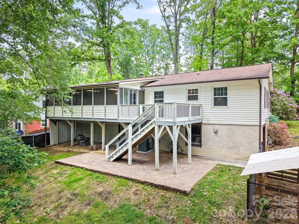 a view of a house with a yard and sitting area
