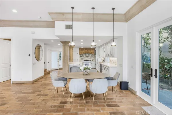 a large white kitchen with a large window