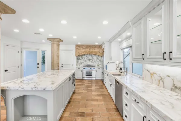 a kitchen with kitchen island a sink stainless steel appliances and cabinets