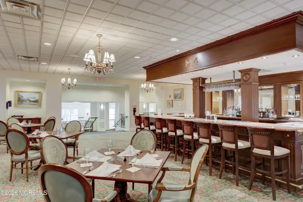 a large dining space with furniture a chandelier and window