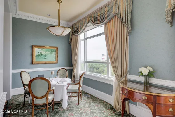 a dining room with furniture a window and wooden floor