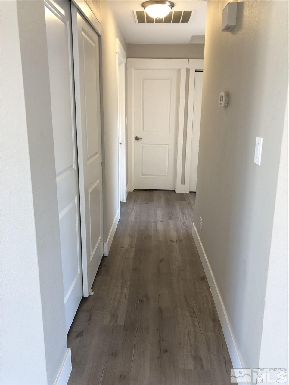 3865 Snipe Drive Reno, NV 89508 - Photo 13 of 19 a view of a hallway with wooden floor