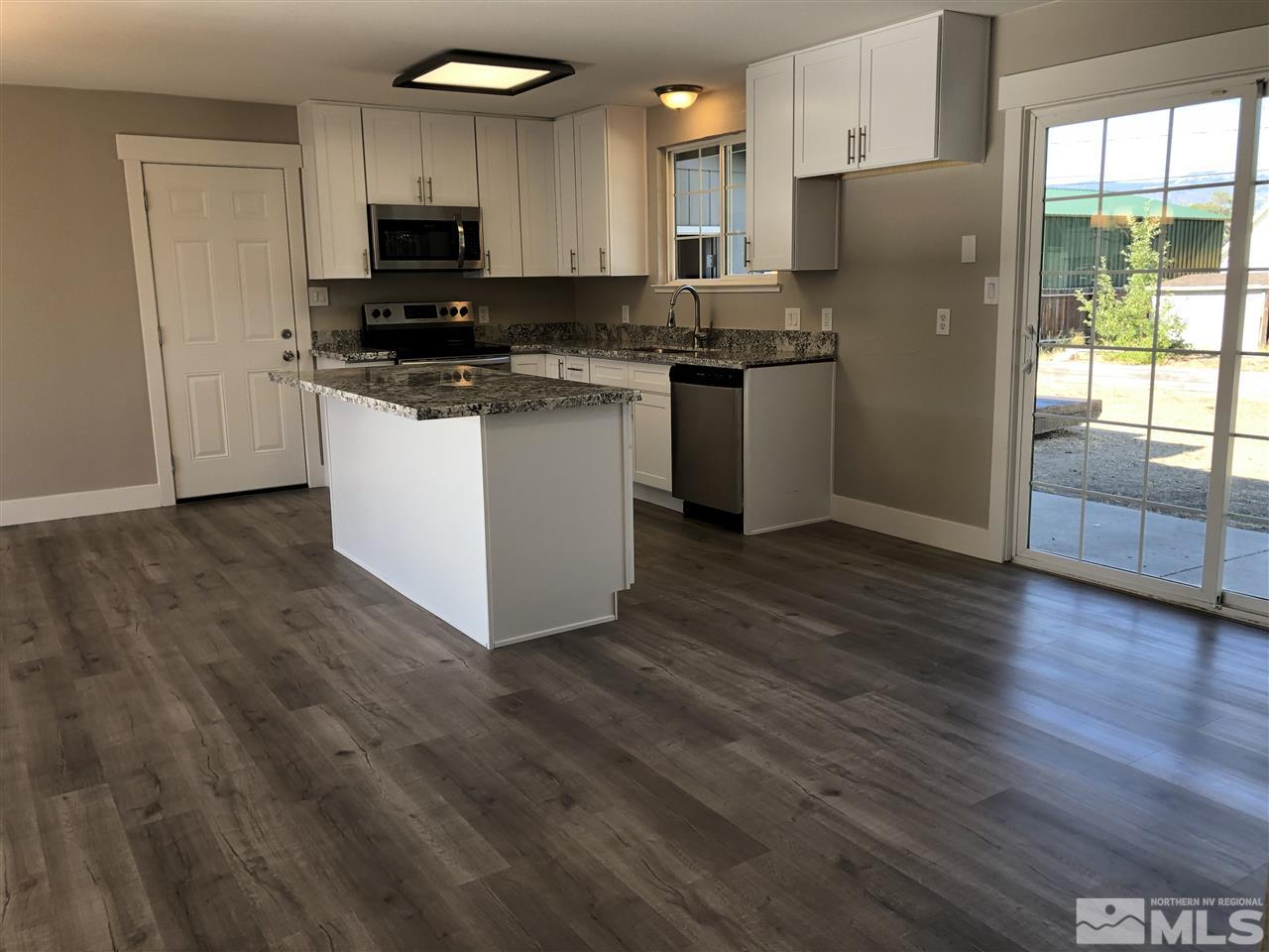 3865 Snipe Drive Reno, NV 89508 - Photo 7 of 19 a kitchen with stainless steel appliances a refrigerator stove microwave and sink