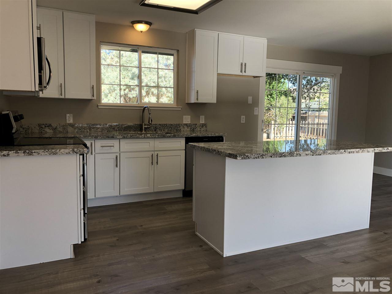3865 Snipe Drive Reno, NV 89508 - Photo 9 of 19 a kitchen with granite countertop a sink cabinets and wooden floor