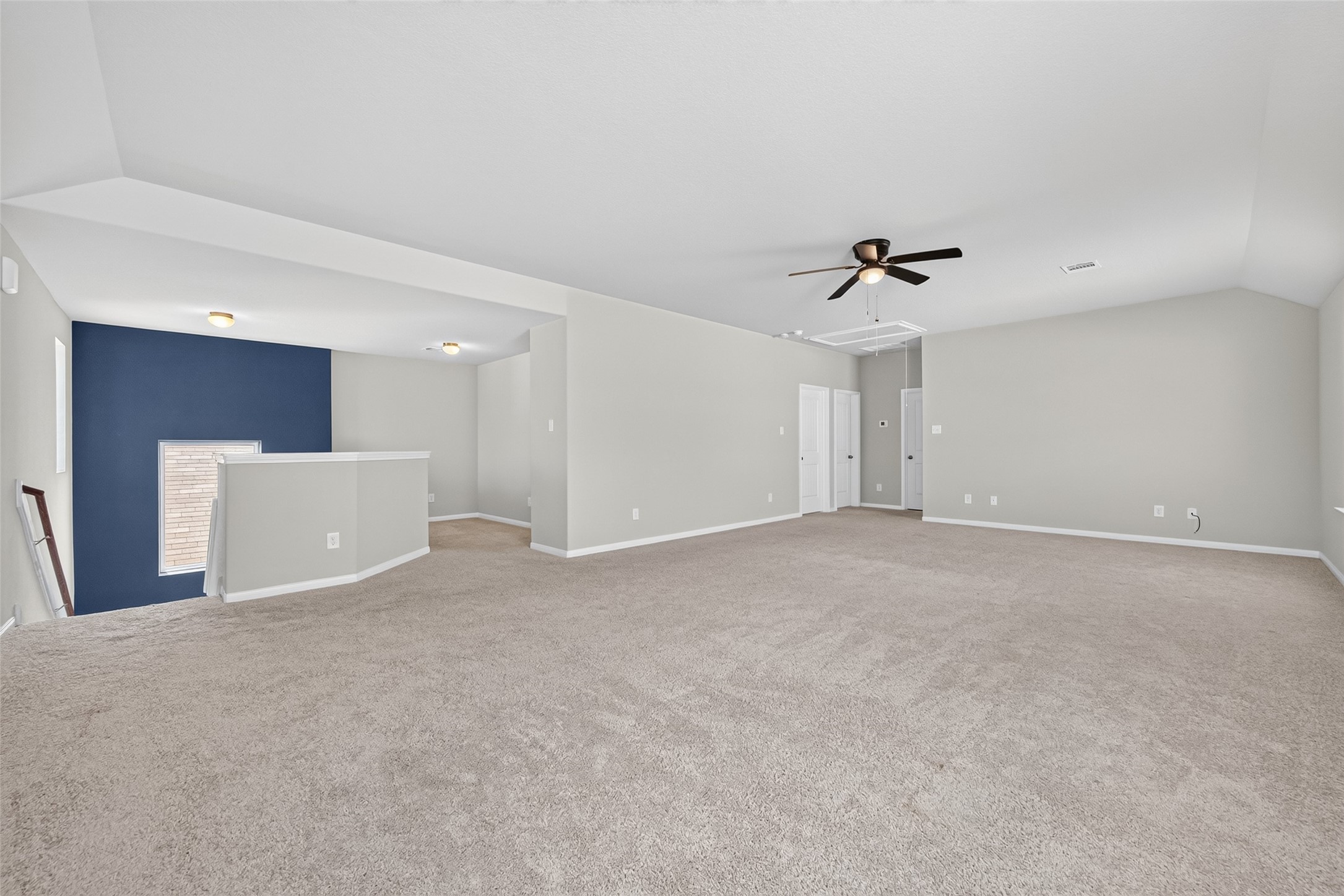2526 Sturgeon Way Conroe, TX 77384 - Photo 28 of 49 Spacious carpeted room with neutral walls and a ceiling fan, featuring a unique architectural layout and a cozy nook with a window.