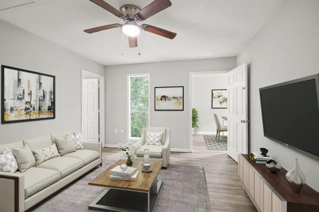 a living room with furniture and a flat screen tv