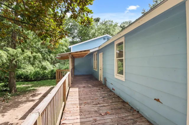 a view of house with backyard and trees