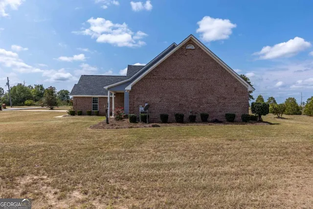 a front view of a house with a yard and a garage