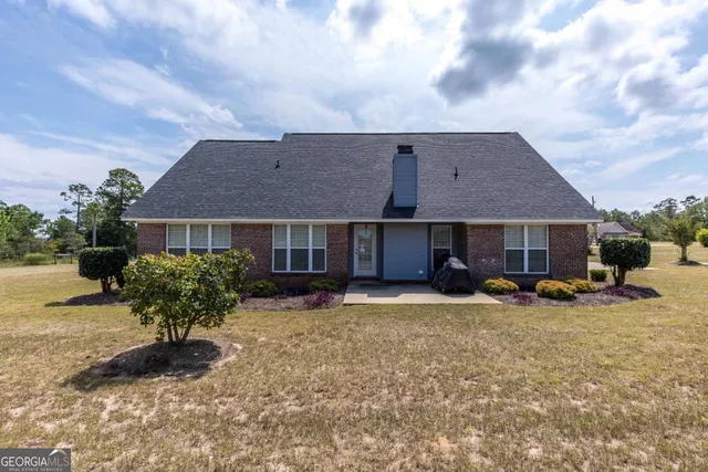 a view of a house with backyard porch and sitting area
