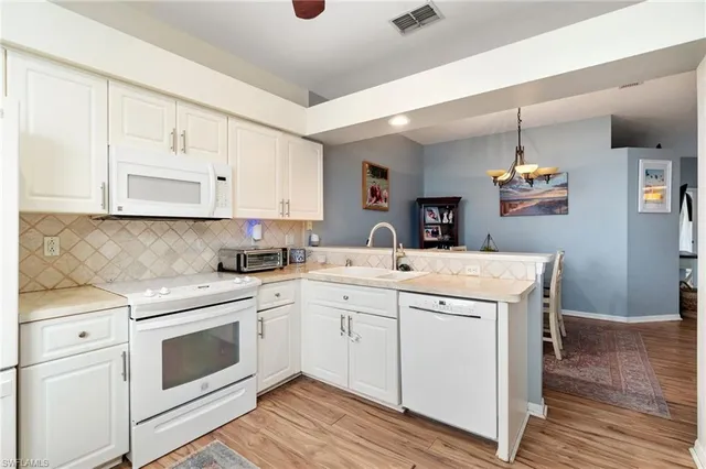 a kitchen with a stove a sink and a refrigerator