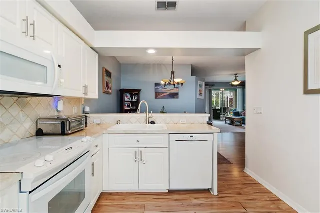 a kitchen with a sink cabinets and window
