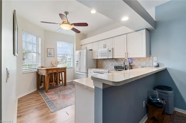 a kitchen with a sink cabinets and window