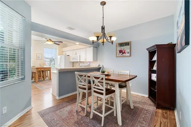 a view of a dining room with furniture wooden floor and a chandelier