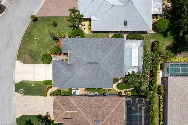 an aerial view of multiple houses with a yard