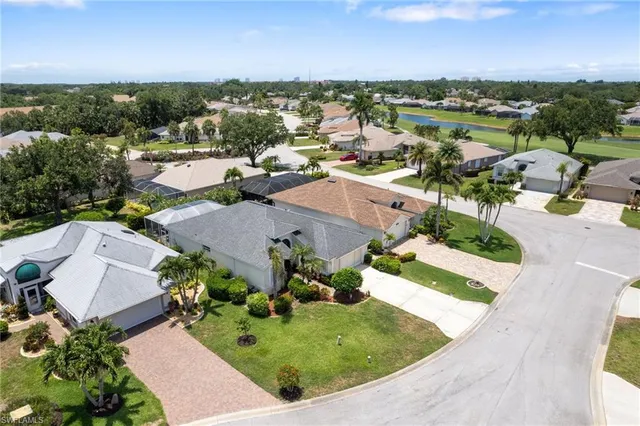 an aerial view of a house with a garden and lake view