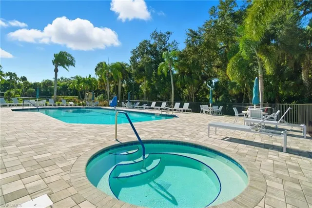 a swimming pool with lots of tress in the background