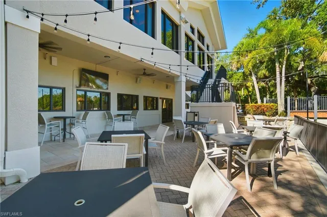 a view of a patio with dining table and chairs