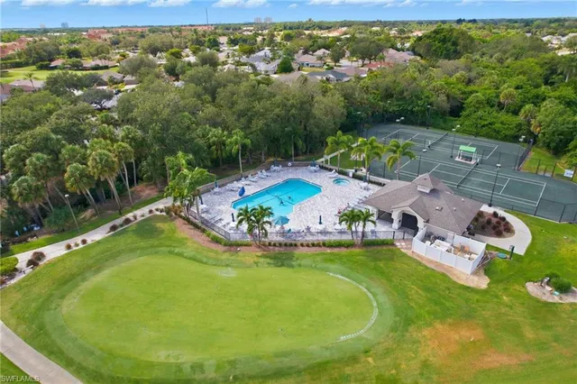 an aerial view of a house with a garden swimming pool