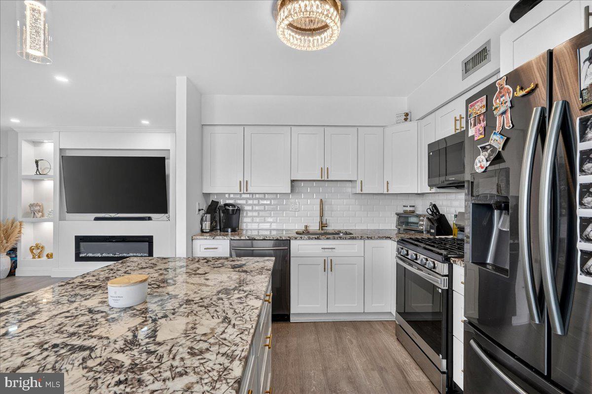 8930 Krewstown Road, Unit 310 Philadelphia, PA 19115 - Photo 6 of 32 a kitchen with stainless steel appliances granite countertop a stove a sink and a refrigerator