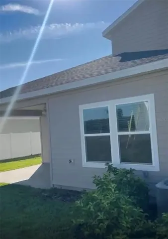 a view of an house with backyard space and swimming pool
