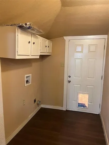 an empty room with wooden floor and window