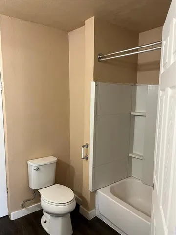 a bathroom with a shower and a toilet