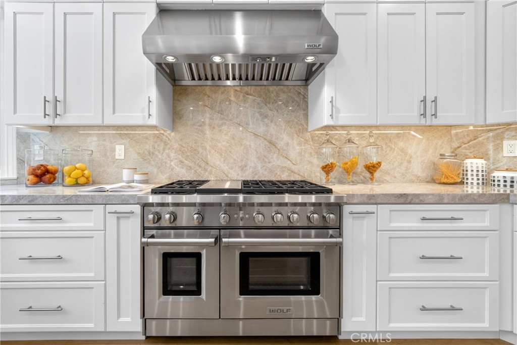 25714 Simpson Place Calabasas, CA 91302 - Photo 12 of 44 a stove top oven sitting inside of a kitchen